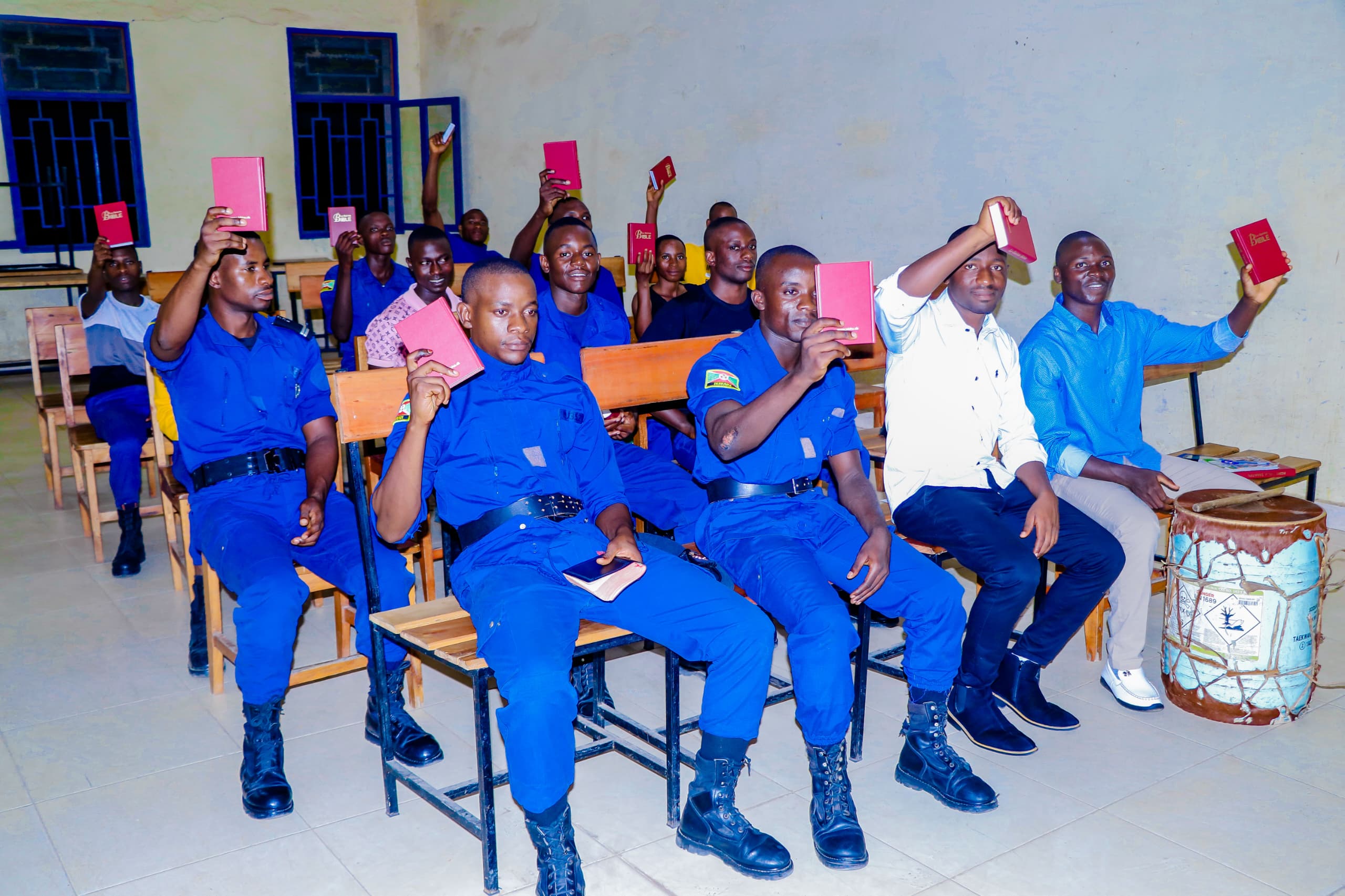 Men in uniform and civilian clothes holding Bibles during a chaplaincy session
